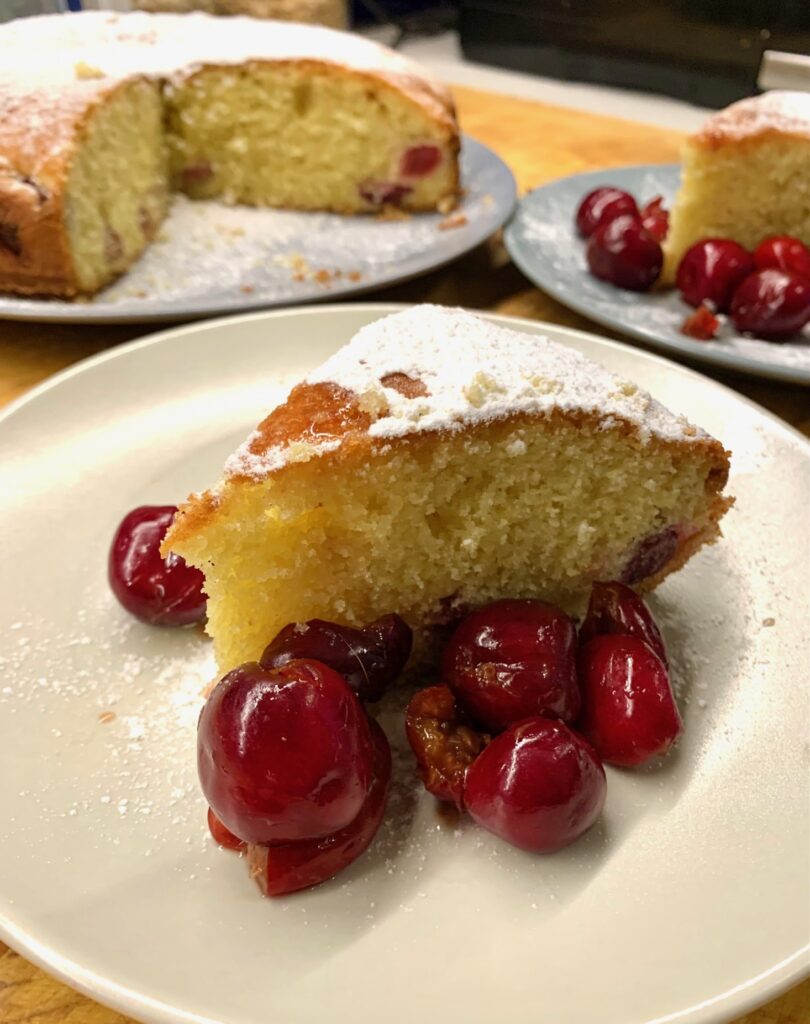 A cake with fresh cherries